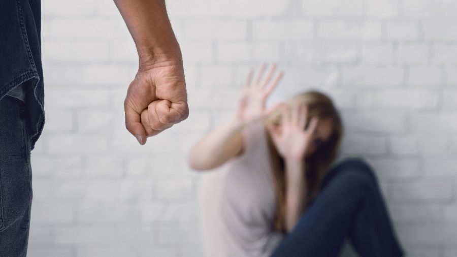 Man Clenches Fist About To Beat Woman, Scared Wife Sits On Floor, Closes Her Face