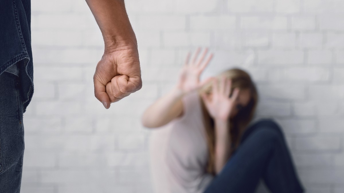 Man Clenches Fist About To Beat Woman, Scared Wife Sits On Floor, Closes Her Face